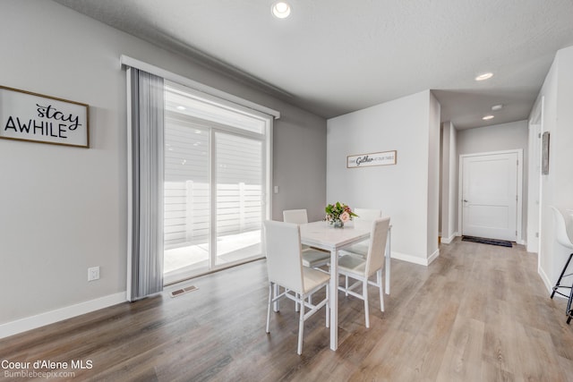 dining space with recessed lighting, baseboards, visible vents, and light wood-style floors