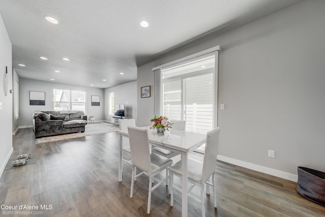 dining space featuring recessed lighting, baseboards, and wood finished floors