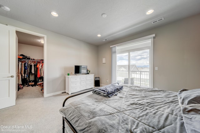 bedroom with carpet flooring, access to outside, visible vents, recessed lighting, and a spacious closet