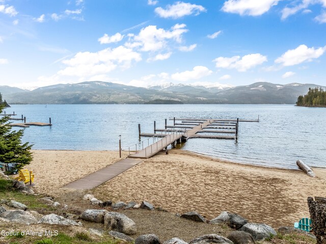 view of dock featuring a water and mountain view