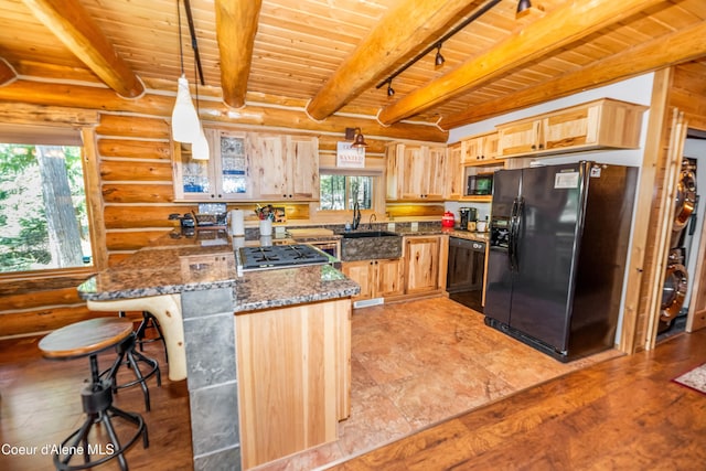 kitchen featuring rustic walls, wooden ceiling, a healthy amount of sunlight, and black appliances