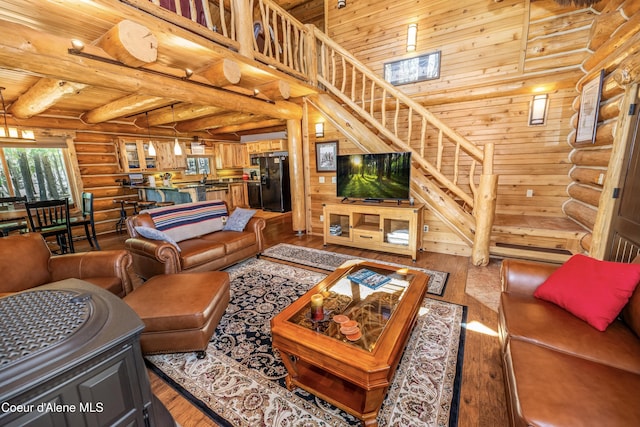 living room featuring wood ceiling, rustic walls, and hardwood / wood-style floors