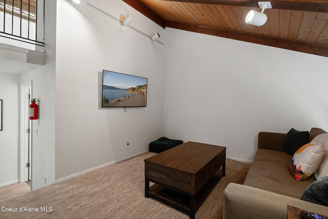 living room with carpet floors, wood ceiling, baseboards, and beamed ceiling