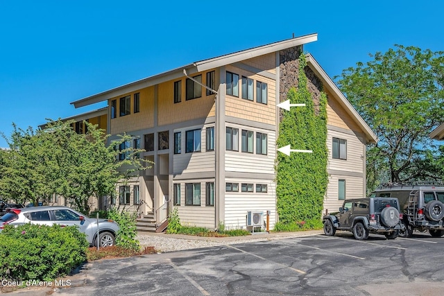 view of building exterior featuring uncovered parking