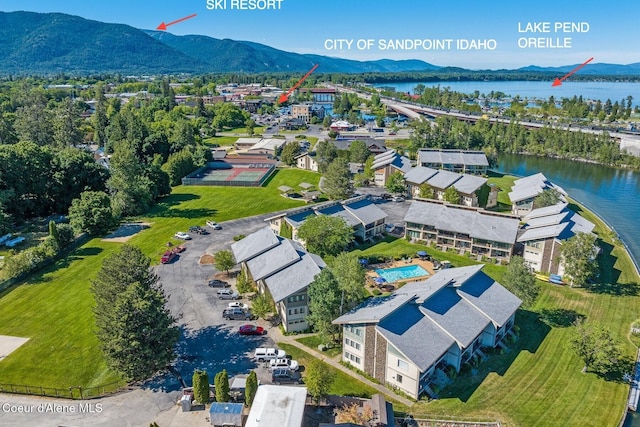 birds eye view of property with a water and mountain view