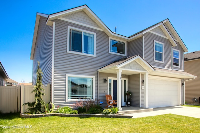 1733 N Minam Loop, Post Falls, ID 83854 - view of front of home featuring a garage, fence, driveway, and a front yard