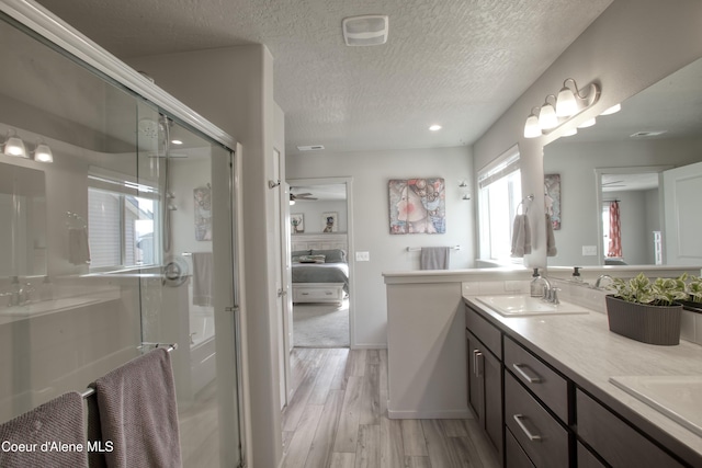1733 N Minam Loop, Post Falls, ID 83854 - ensuite bathroom featuring double vanity, wood finished floors, a shower stall, and a sink