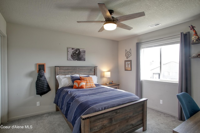 1733 N Minam Loop, Post Falls, ID 83854 - bedroom featuring light carpet, baseboards, visible vents, a ceiling fan, and a textured ceiling