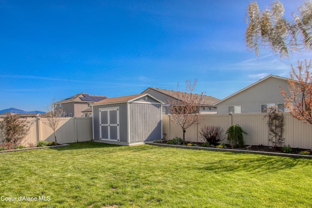 1733 N Minam Loop, Post Falls, ID 83854 - view of yard with an outdoor structure, a storage shed, and a fenced backyard