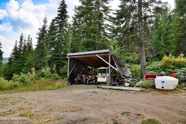NNA Blake Creek Rd, Saint Maries, ID 83861 - view of vehicle parking with a view of trees, a detached carport, and dirt driveway