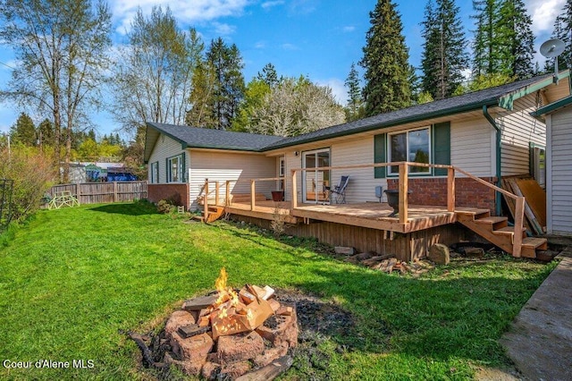 820 Plum Ln, Saint Maries, ID 83861 - back of property with a lawn, a fire pit, fence, and a wooden deck