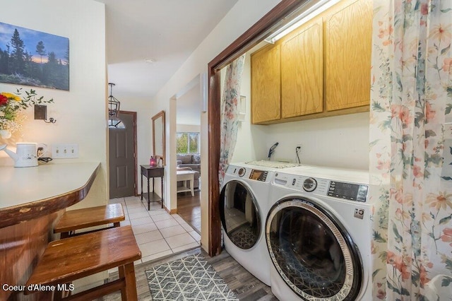 820 Plum Ln, Saint Maries, ID 83861 - washroom with separate washer and dryer, light wood-style flooring, and cabinet space
