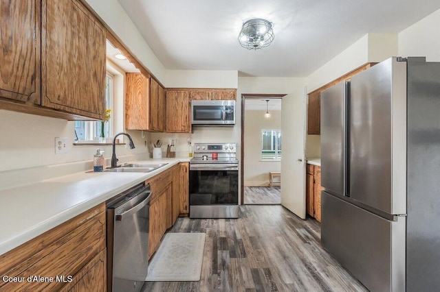 820 Plum Ln, Saint Maries, ID 83861 - kitchen featuring a sink, appliances with stainless steel finishes, brown cabinetry, and dark wood-type flooring