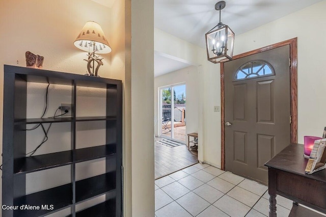 820 Plum Ln, Saint Maries, ID 83861 - foyer with light tile patterned floors and a notable chandelier