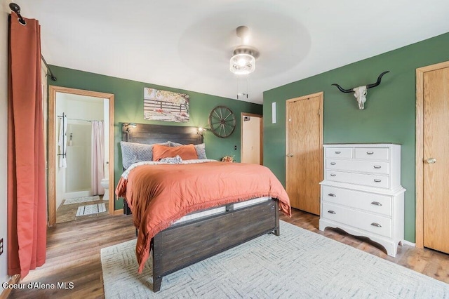 820 Plum Ln, Saint Maries, ID 83861 - bedroom featuring baseboards, ceiling fan, ensuite bathroom, and wood finished floors