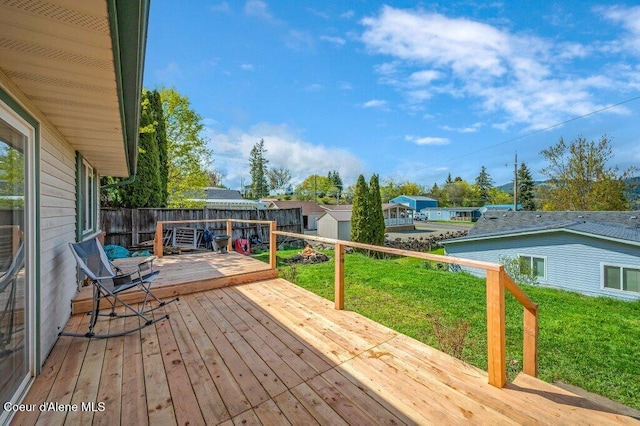 820 Plum Ln, Saint Maries, ID 83861 - wooden terrace with a residential view, a shed, a fenced backyard, a lawn, and an outdoor structure
