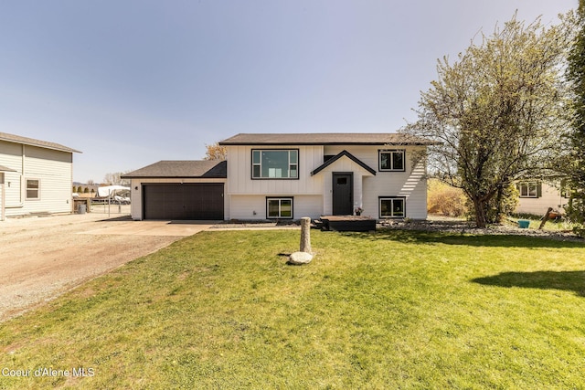 split foyer home featuring a garage, board and batten siding, concrete driveway, and a front yard