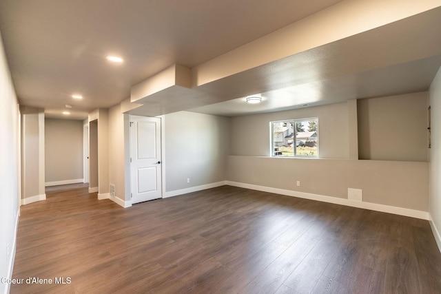 basement with baseboards, recessed lighting, and dark wood finished floors