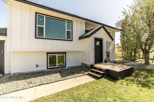 view of front of property featuring board and batten siding and a front yard