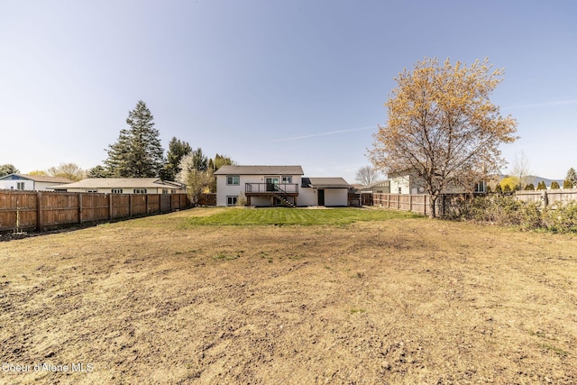 view of yard featuring stairs, a fenced backyard, and a deck