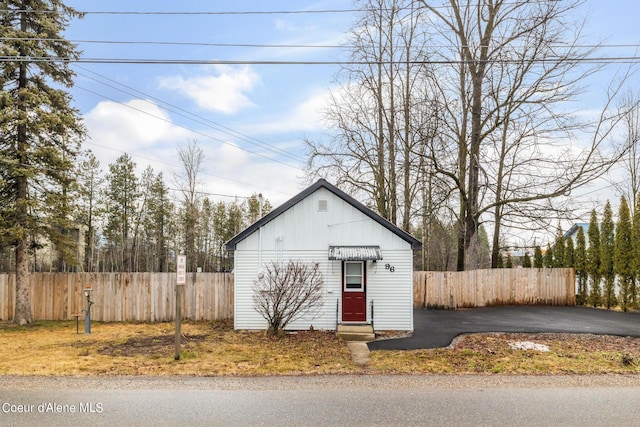 view of outbuilding with fence and entry steps