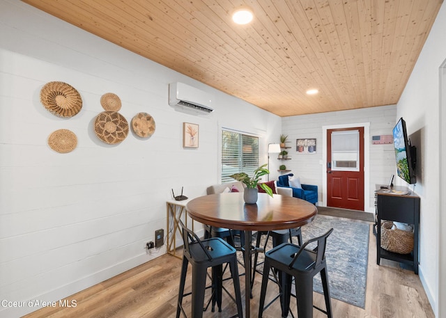 dining room featuring wooden walls, wooden ceiling, a wall unit AC, and wood finished floors