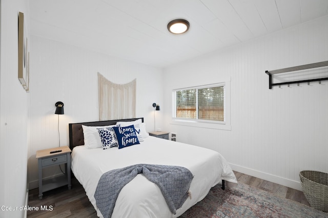 bedroom featuring baseboards and wood finished floors