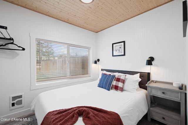 bedroom featuring heating unit and wooden ceiling