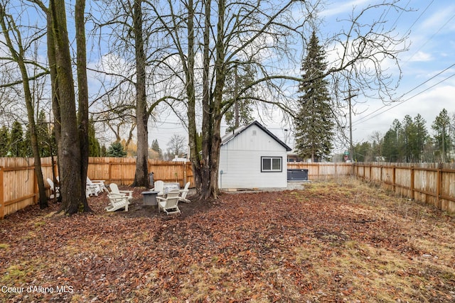 view of yard with a fenced backyard and an outdoor fire pit