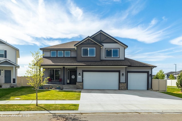1622 N Minam Loop, Post Falls, ID 83854 - view of front facade with a porch, concrete driveway, a garage, and a shingled roof