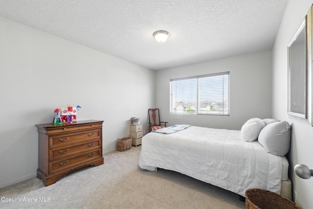 1622 N Minam Loop, Post Falls, ID 83854 - bedroom featuring light carpet and a textured ceiling