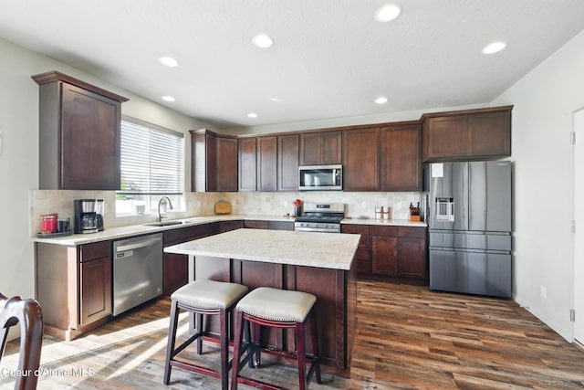 1622 N Minam Loop, Post Falls, ID 83854 - kitchen with appliances with stainless steel finishes, a sink, dark wood-style flooring, recessed lighting, and decorative backsplash