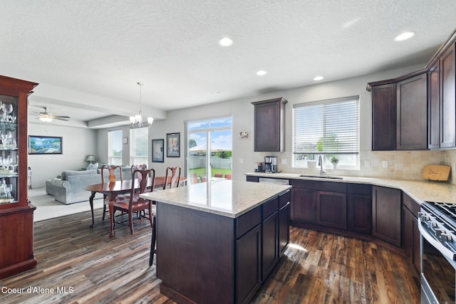 1622 N Minam Loop, Post Falls, ID 83854 - kitchen with stainless steel gas stove, a sink, dark wood-style floors, recessed lighting, and open floor plan