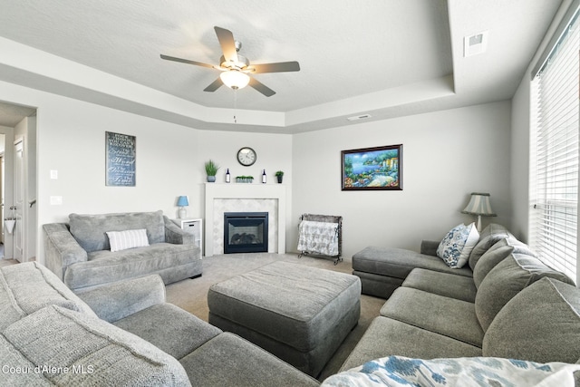 1622 N Minam Loop, Post Falls, ID 83854 - carpeted living room featuring a raised ceiling, ceiling fan, and a premium fireplace