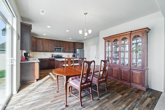 1622 N Minam Loop, Post Falls, ID 83854 - dining room with wood finished floors, a chandelier, and recessed lighting
