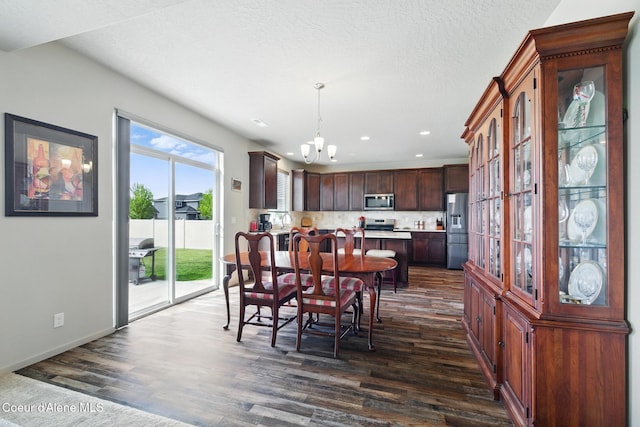 1622 N Minam Loop, Post Falls, ID 83854 - dining area featuring a chandelier, dark wood-type flooring, recessed lighting, and baseboards