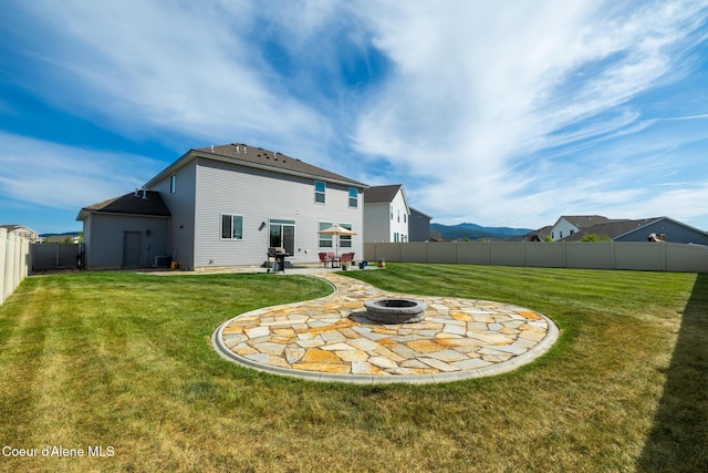 1622 N Minam Loop, Post Falls, ID 83854 - rear view of house with a fire pit and a patio area