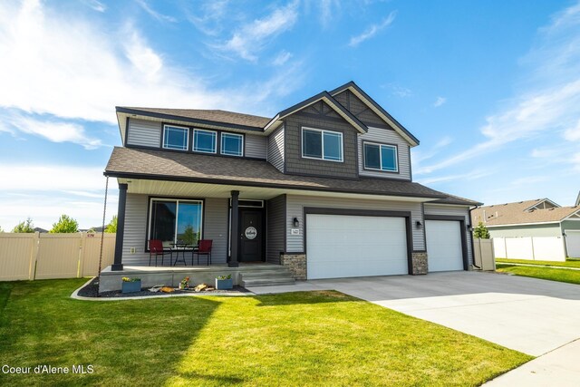 1622 N Minam Loop, Post Falls, ID 83854 - view of front facade featuring covered porch, a garage, driveway, and a shingled roof
