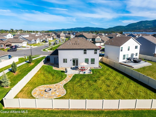 1622 N Minam Loop, Post Falls, ID 83854 - back of house with a residential view, a patio, an outdoor fire pit, a mountain view, and roof with shingles