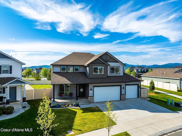 1622 N Minam Loop, Post Falls, ID 83854 - view of front of house featuring a porch, a residential view, roof with shingles, and driveway