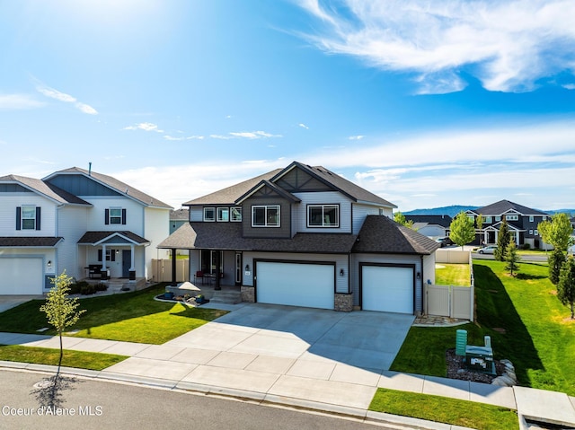 1622 N Minam Loop, Post Falls, ID 83854 - view of front of house featuring concrete driveway, a shingled roof, covered porch, and an attached garage