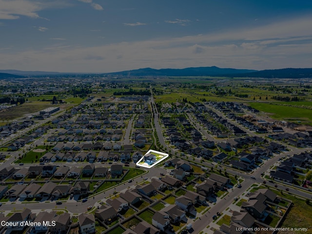 1622 N Minam Loop, Post Falls, ID 83854 - aerial view of property's location with property boundaries highlighted, a mountain backdrop, and nearby suburban area