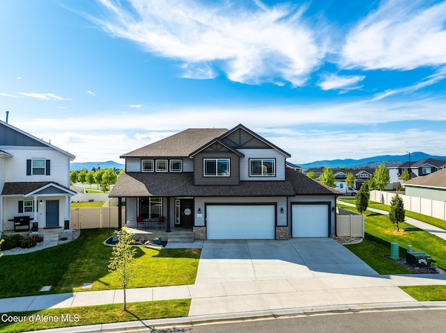 1622 N Minam Loop, Post Falls, ID 83854 - view of front of home featuring covered porch, a mountain view, roof with shingles, and a garage