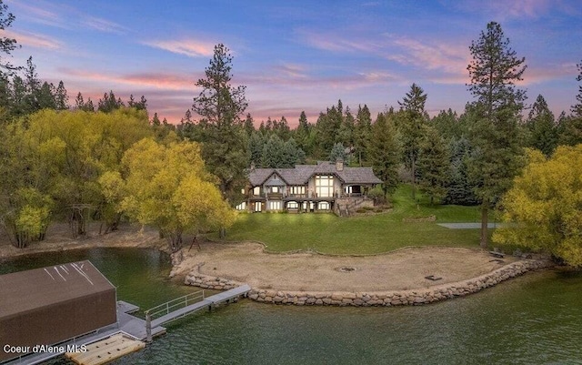 7566 E Gem Shores Rd, Hayden, ID 83835 - aerial view at dusk with a water view and a forest view