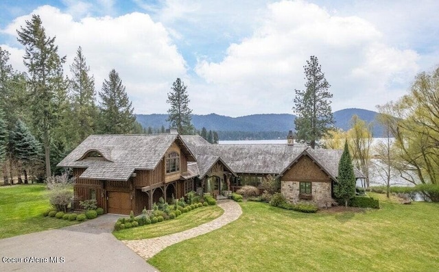 7566 E Gem Shores Rd, Hayden, ID 83835 - view of front of home featuring a garage, a chimney, driveway, and a front yard