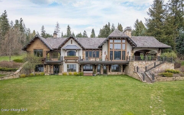 7566 E Gem Shores Rd, Hayden, ID 83835 - back of house with a chimney, a yard, stucco siding, and stairway