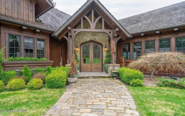 7566 E Gem Shores Rd, Hayden, ID 83835 - property entrance featuring board and batten siding, french doors, and stone siding