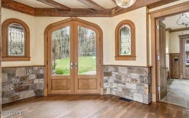 7566 E Gem Shores Rd, Hayden, ID 83835 - doorway with french doors, a wainscoted wall, a healthy amount of sunlight, and wood finished floors