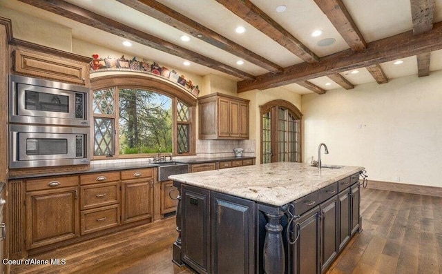 7566 E Gem Shores Rd, Hayden, ID 83835 - kitchen featuring a sink, decorative backsplash, dark wood-style flooring, and beamed ceiling
