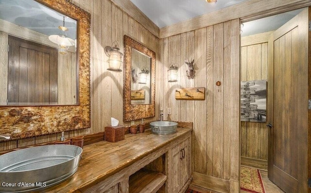 7566 E Gem Shores Rd, Hayden, ID 83835 - full bathroom with double vanity, a sink, and wooden walls
